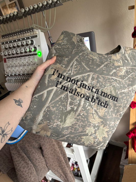 I’m not just a mom deadwood camo CREWNECK